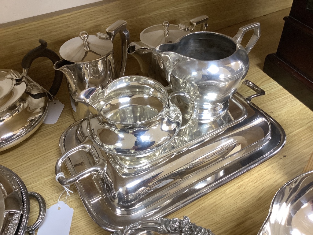 A collection of plated items, including a three-piece tea service, four entrée dishes and covers, various